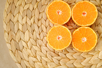 four halves of citrus on a wicker background on the table