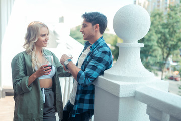 Couple standing on balcony in the morning and drinking coffee