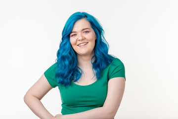 Youth, stylish and fashion concept - Young beautiful woman with blue hair is smiling over white background