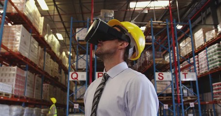 Male warehouse manager in VR goggles 4k - Powered by Adobe