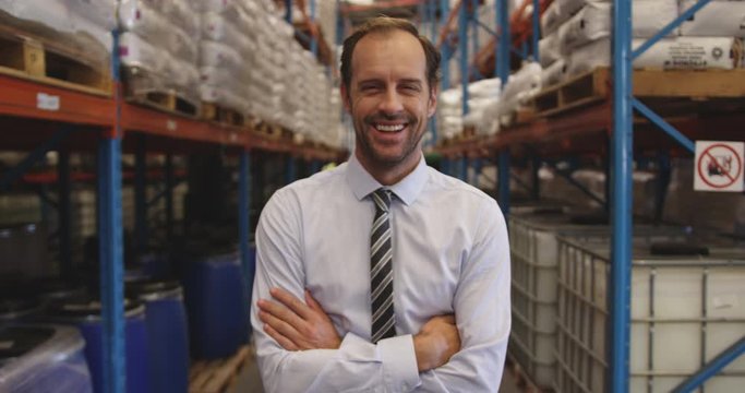 Portrait of male manager smiling in a warehouse 4k