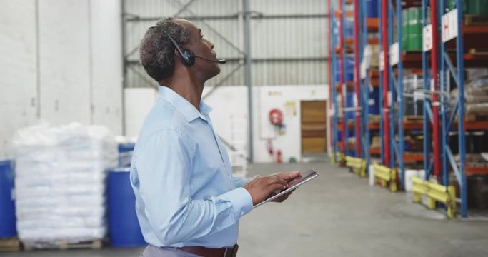 African American man warehouse worker using tablet computer 4k