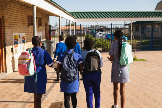 Schoolchildren walking in the playground at a township school
