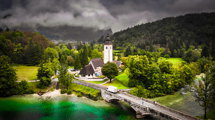 Fototapeta na wymiar Church by the Bohinj lake in national park Triglav, part of Julian Alps in Slovenia.