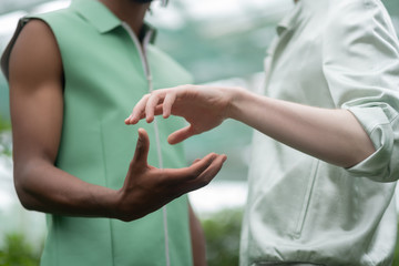 Models standing and posing while almost touching hands