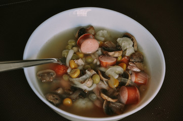 bowl of soup with meat and vegetables with fork