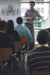 Young male speaker speaks in a business seminar