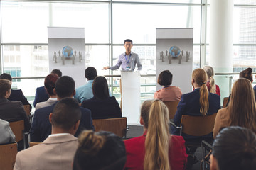 Businessman speaks to group at a business seminar