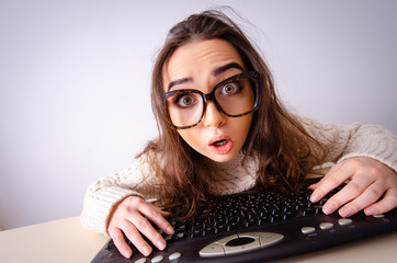 Funny nerd girl working on computer