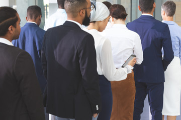 Business people checking in at conference registration table
