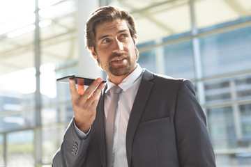 Fototapeta premium Businessman talking on mobile phone in lobby office