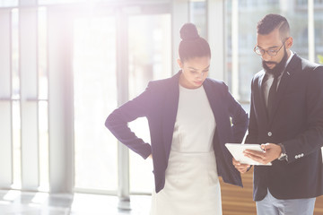 Business people looking and  discussing over digital tablet in office