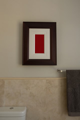 Empty frame and towel in bathroom