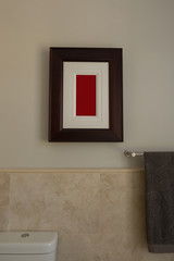 Empty frame and towel in bathroom