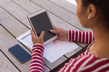 Woman using digital tablet at home