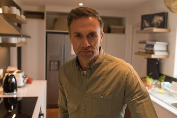 Fototapeta premium Man standing in kitchen at home