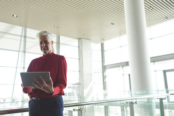 Fototapeta premium Senior businesswoman using digital tablet in office building