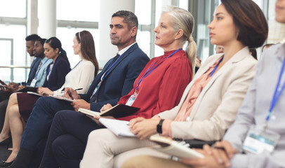 Side view of business people attending a business seminar