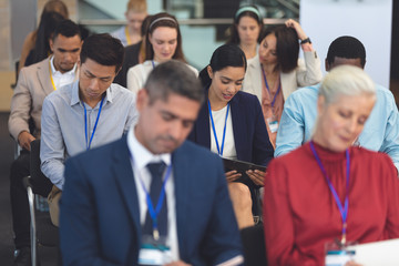 Young businesswoman reading document in a business seminar