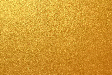 Gold concrete wall on background texture.