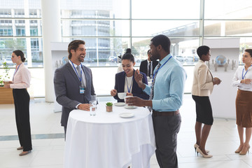 Business people interacting with each other at table during a seminar