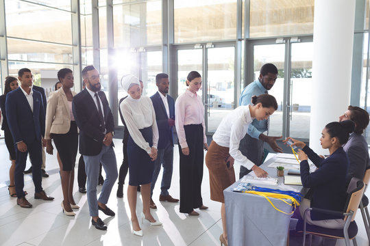 Business people checking in at conference registration table