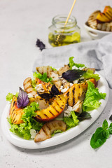Grilled peach feta summer salad. Selective focus, copy space.