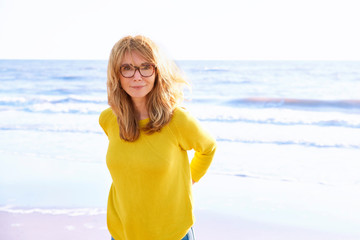 Confident mature woman walking on the street and enjoy summer breeze