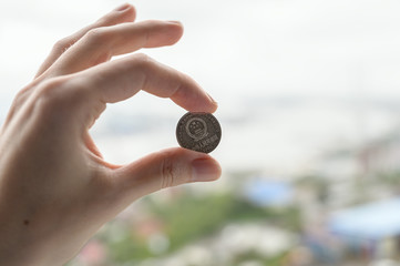 Chines money in hand over city background.