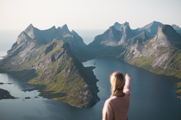 person pointing to the mountains. Lofoten Islands view