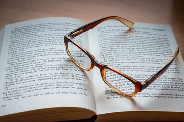 Reading a book with reading glasses, a device required when you get older than forty years.