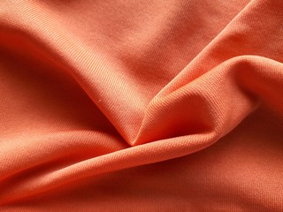 Orange  background fabric Swaying like a silk thread when hit by the wind.