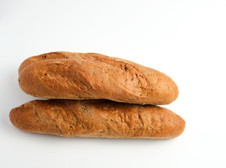 stack of whole baked baguettes from rye flour on a white background