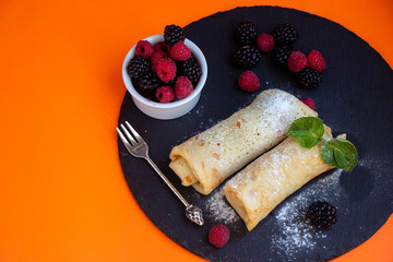 piece of chocolate cake on a plate with fork and knife