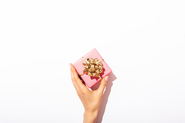 Small pink gift box with golden bow