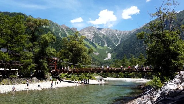 中部山岳国立公園上高地の河童橋を渡る観光客と穂高連峰