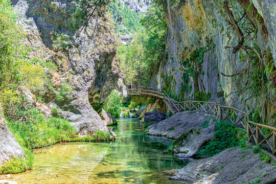 Route of the birth of the borosa river, with large rocks in the valley and a walkway for visitors. Photography taken in the Mountain Range of Cazorla, Jaen, Spain.