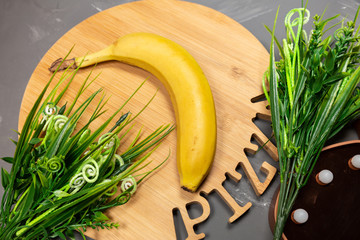 Banana, wooden tray and artificial grass