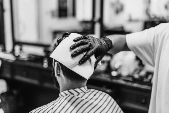 Men's haircut. Haircut with scissors. Black and white photo.
