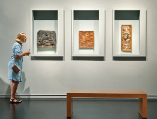 visitor looking pictures in art gallery museum