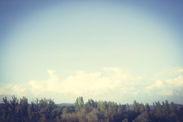 Autumn urban landscape on a Sunny day - yellow and colorful autumn trees, the sky with clouds with autumn haze