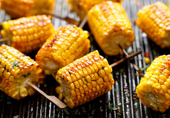 Grilled corn on the cob with butter and  salt  on the grill plate, close-up - Powered by Adobe