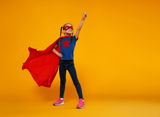 concept of child superhero costume on yellow background