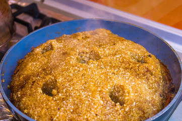 Preparation of Uzbek pilaf - evaporation of water from rice, close up