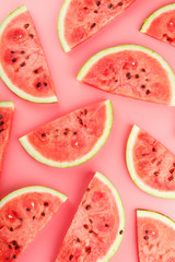 Juicy slices of red watermelon on a bright pink background. Conceptual colors of summer. Patterns...