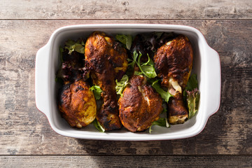 Roasted tandoori chicken with basmati rice on wooden table. Top view