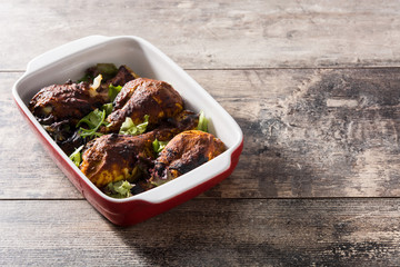 Roasted tandoori chicken with basmati rice on wooden table. Copyspace