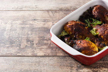 Roasted tandoori chicken with basmati rice on wooden table. Copyspace