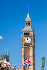 Fototapeta na wymiar Big Ben with flags of England in London, UK
