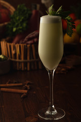 cocktail dekorate parsley on a wooden background. Background decorated with fruits and herbs.